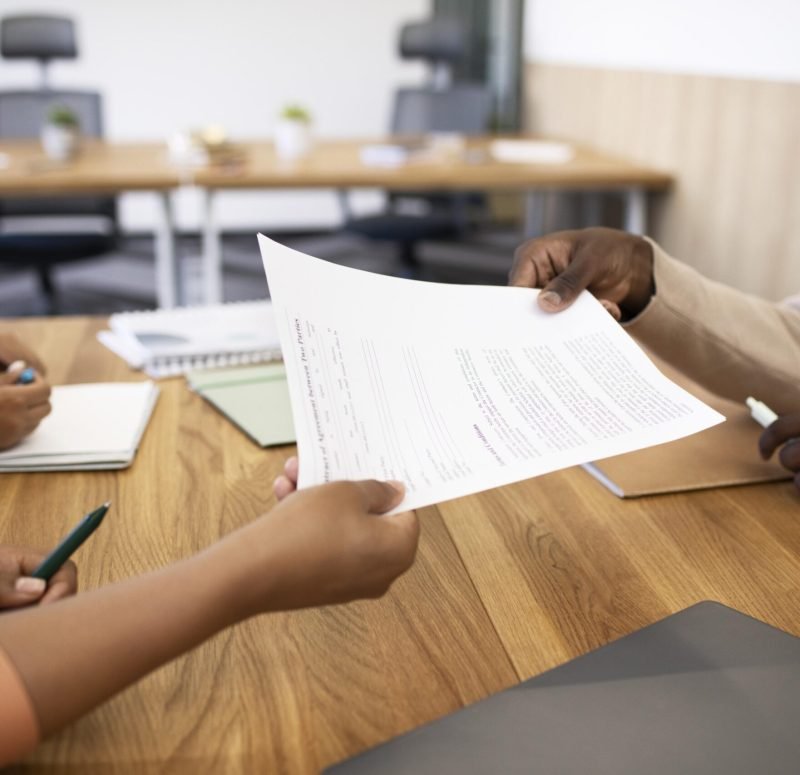 man-holding-contract-his-new-office-job-after-interview (1)